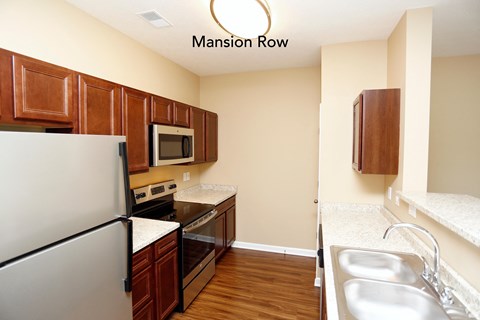 a kitchen with stainless steel appliances and wooden cabinets